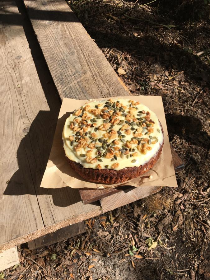 A delicious cake topped with walnuts and pumpkin seeds