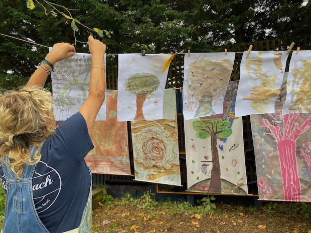 hanging artwork in front of forest hangings