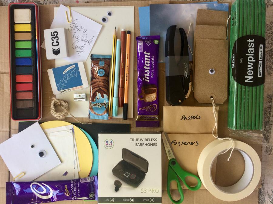 A box of objects including art materials
