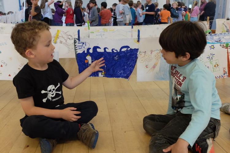 two boys discuss artwork